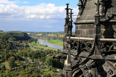 Meissen cathedral by elbe river against sky in town