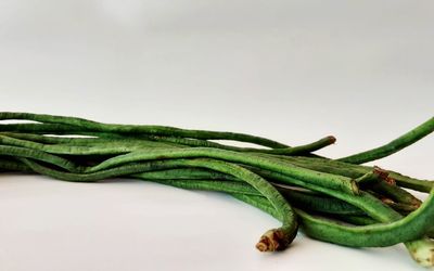 Close-up of vegetables on table against white background