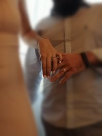 Midsection of woman holding hands with text