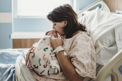 Woman lying on bed at home