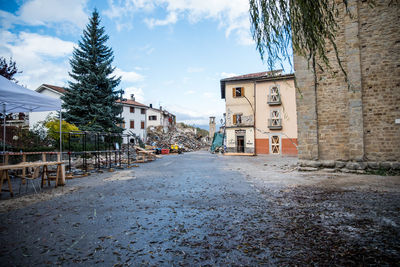 Street amidst buildings against sky