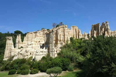 Low angle view of old ruins against blue sky