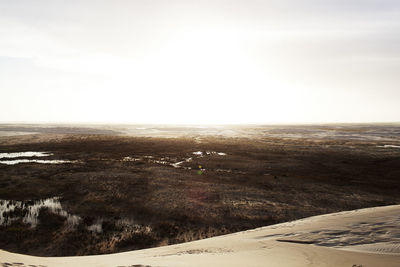 Scenic view of landscape against sky during winter