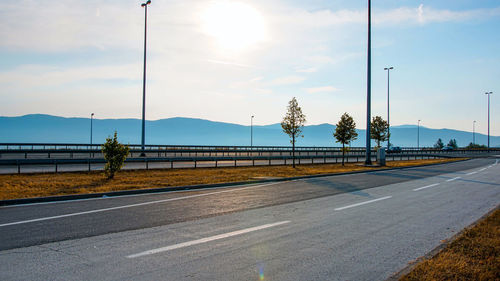 Street by road against sky