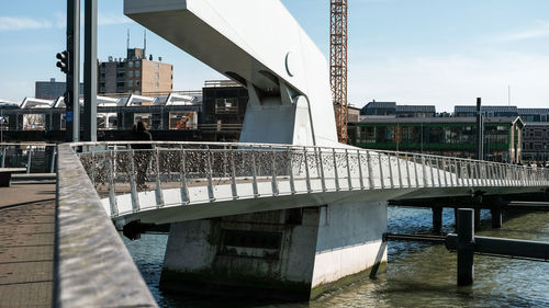 Railway bridge over water against sky