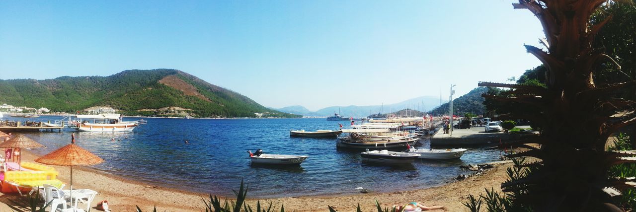 nautical vessel, water, boat, transportation, mode of transport, moored, clear sky, sea, mountain, blue, copy space, tranquility, tranquil scene, scenics, nature, beauty in nature, travel, sailboat, day, sky