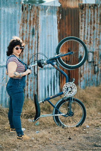 Woman standing with vintage bicycle