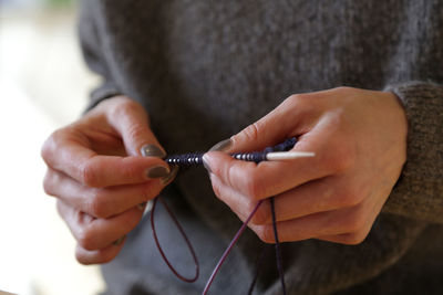 Close-up of woman holding knitting needle