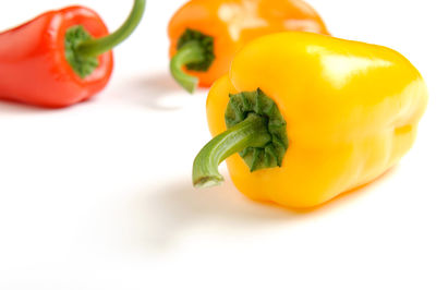 Close-up of yellow bell peppers on white background