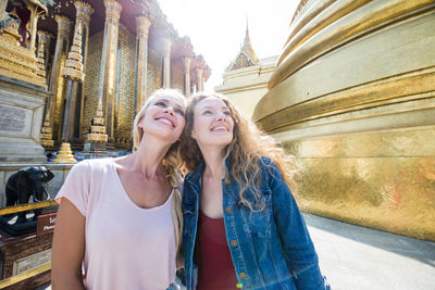 Happy women at temple in city