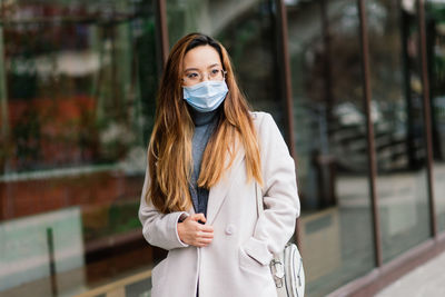 Portrait of beautiful young woman standing outdoors