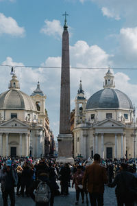 Group of people in front of building against sky