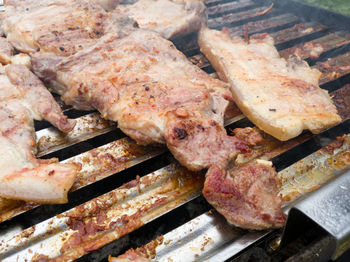 High angle view of meat on barbecue grill