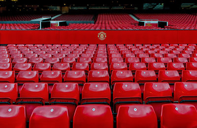 Full frame shot of red chairs in stadium