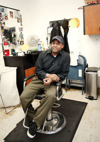 Portrait of barber sitting in chair