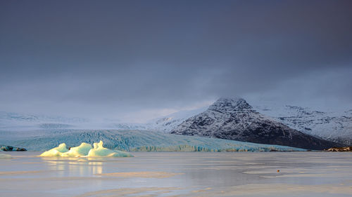 Iceland svínafellsjökull glacier  a combo of the golden iceberg, dark mountain and blue glacier