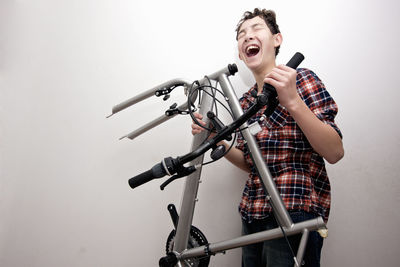 Boy is assembling his new mountain bike at home