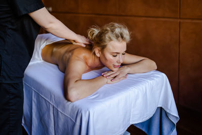 Young woman lying on bed at home