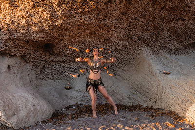 Young woman standing on rock