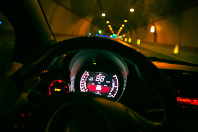 Illuminated car seen through windshield