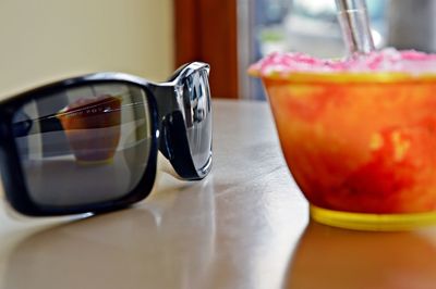 Close-up of fresh ice cream with reflection on sunglasses at home