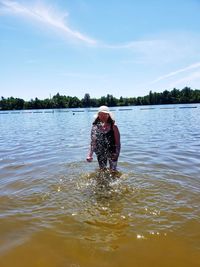 Full length of woman in lake against sky