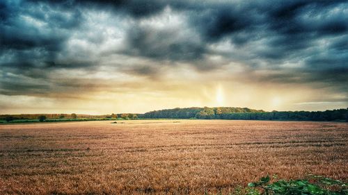 Scenic view of landscape against cloudy sky