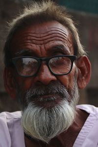 Close-up portrait of senior man wearing eyeglasses