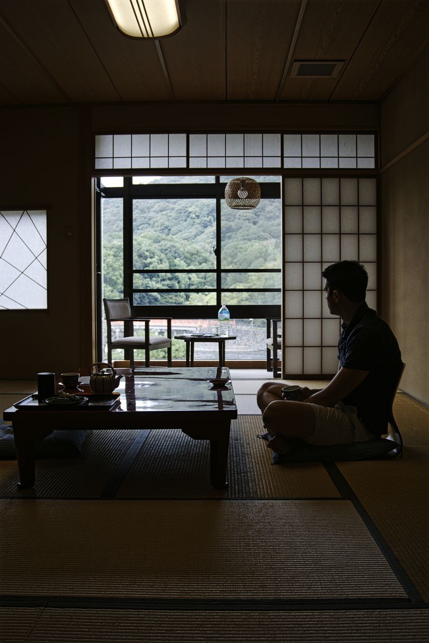 indoors, sitting, hardwood floor, person, day