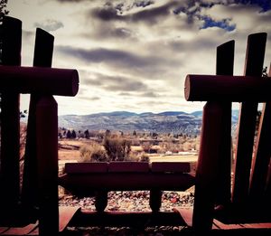 Close-up of seats on table against mountain range