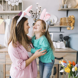 Happy girl and woman on table