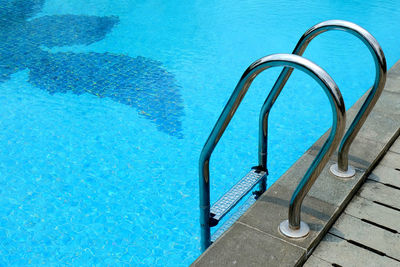 High angle view of metal railing at swimming pool