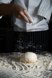 Midsection of man preparing food