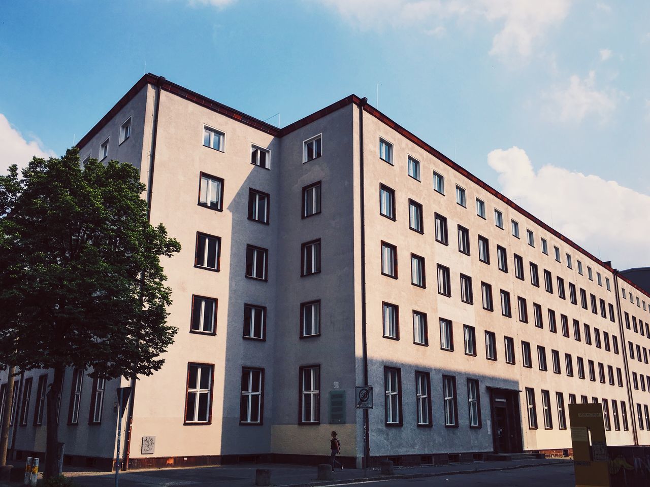 architecture, building exterior, built structure, sky, residential building, building, residential structure, tree, low angle view, city, day, outdoors, facade, cloud, no people, cloud - sky, apartment, blue, exterior, residential district, sunny, city life, growth, nature, repetition