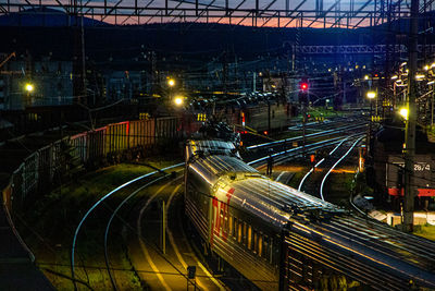 High angle view of railroad tracks in city at night