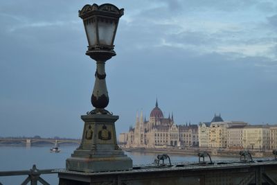 Gas light by hungarian parliament building against sky