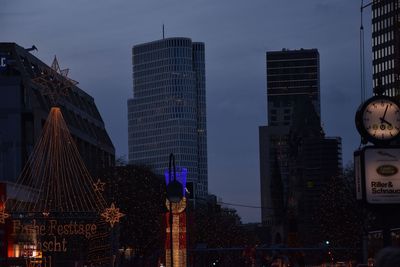 Sculpture in city against sky