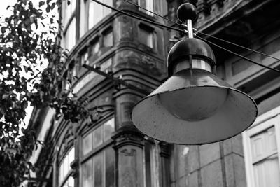 Low angle view of lamp hanging against building