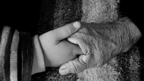 Close-up of hands touching baby