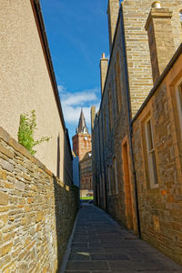 Narrow alley amidst buildings in city