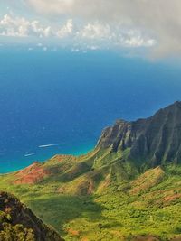 Scenic view of sea and mountains against sky