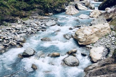 Stream flowing through rocks in forest