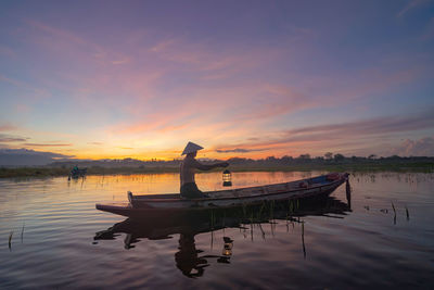 Scenic view of lake against sky during sunset