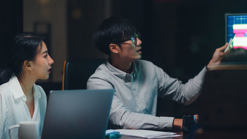 Rear view of senior man using laptop