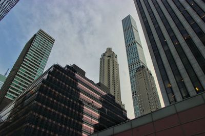 Low angle view of modern buildings against sky in city