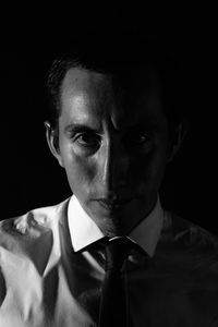 Portrait of serious businessman in darkroom