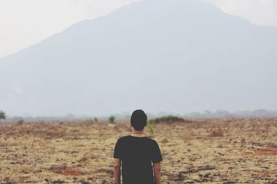 Rear view of man on landscape against mountain