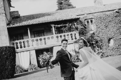 Couple kissing against building