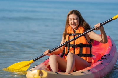 Portrait of woman kayaking in sea