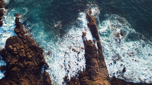 Waves breaking against the rocks in sri lanka